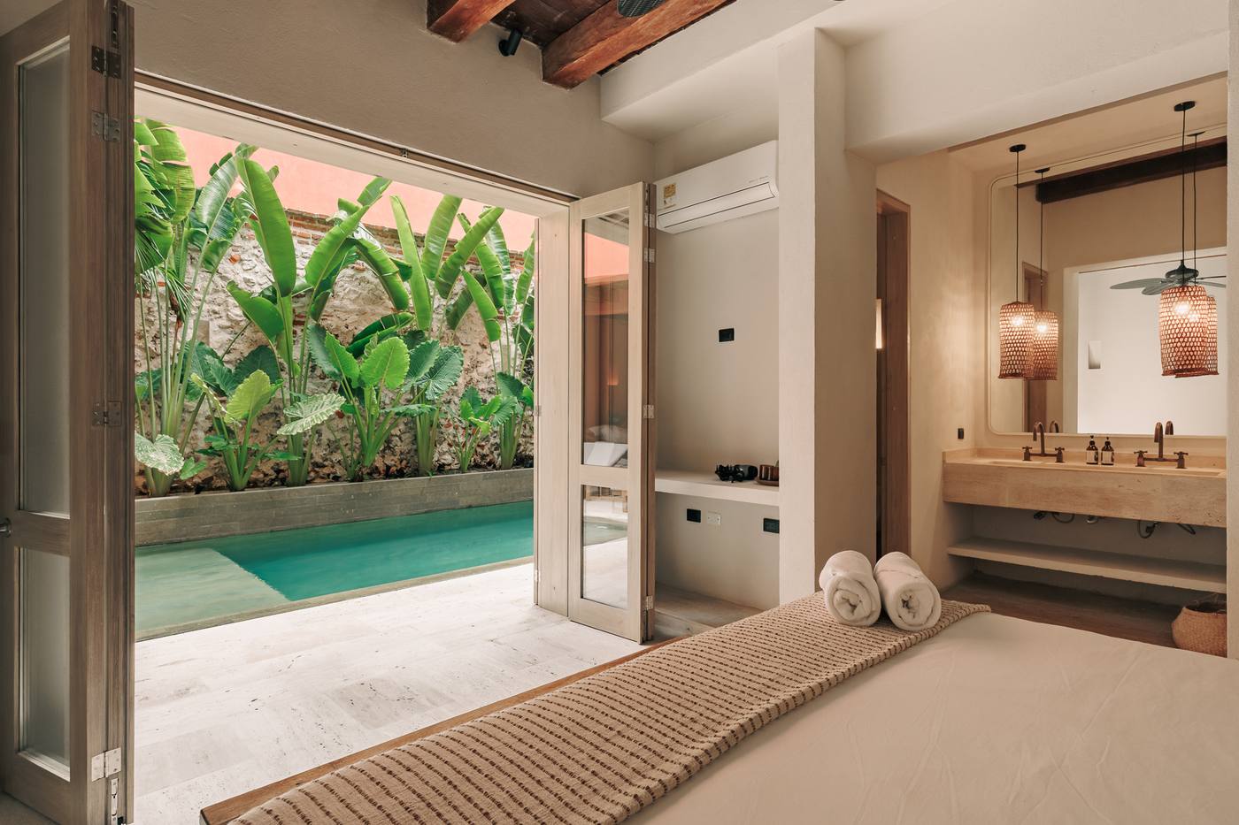 Bedroom opening onto the private pool and garden at Casa Kai